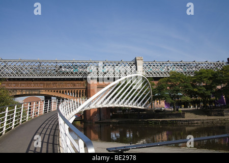 Manchester England UK Pedestrian footbridge over Giant canal basin and railway bridges in Castlefields area of city world's first urban heritage park Stock Photo