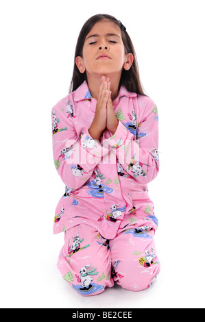 Young girl praying before bedtime isolated over a white background Stock Photo