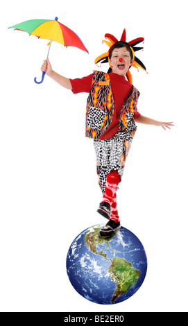 Young clown balancing on planet earth Stock Photo