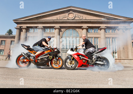 Two stunt riders making wheelie Stock Photo - Alamy