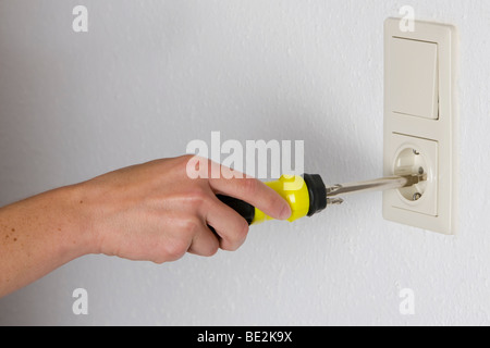 Household accident, screwdriver in a socket Stock Photo