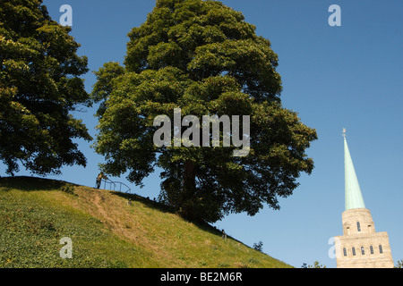 [Oxford Castle Mound], trees growing on hill in summer, [Nuffield College] spire in background, Oxford, Oxfordshire, England, UK
