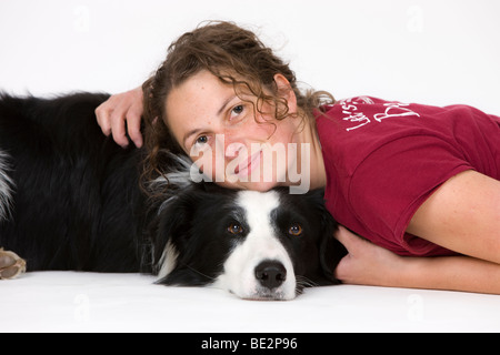 Girl cuddling with Border Collie, male Stock Photo