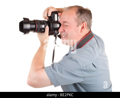 A male photographer is shooting something or someone. Stock Photo