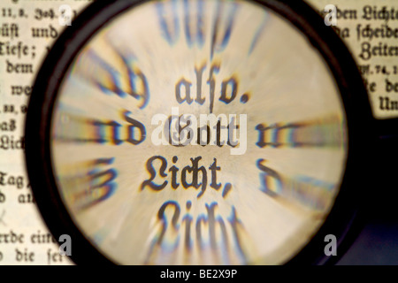 The Word "Gott", god in an old Bible, seen through a magnifying glass Stock Photo