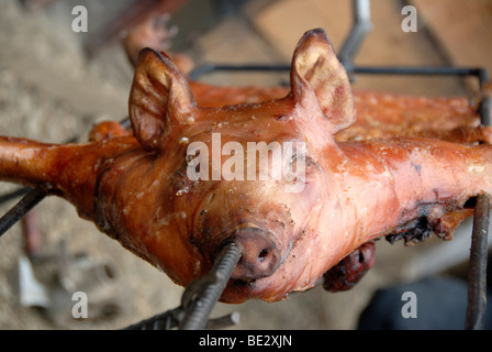 Suckling pig on a spit, Lige, Lugu Hu Lake area, Yunnan Province, People's Republic of China, Asia Stock Photo