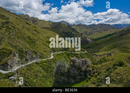 Winding dirt road in the verdant Skippers Canyon, Queenstown, South Island, New Zealand Stock Photo