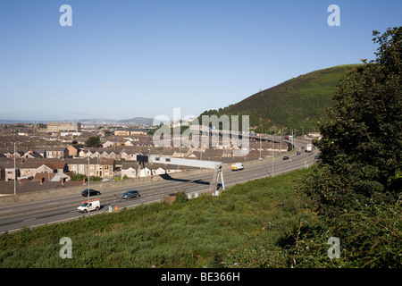 M4 motorway, an elevated road at junction 40 Port Talbot with 50 mph speed limit and with Swansea and Gower in distance Stock Photo