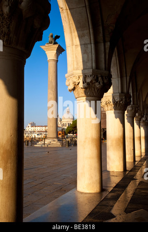 Looking through the columns of the Ducal Palace near Piazza San Marco, Venice Veneto Italy Stock Photo
