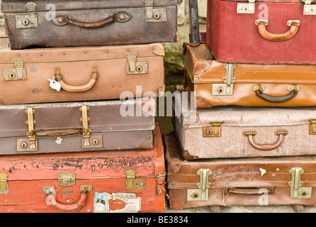Old battered suitcases in a pile Stock Photo