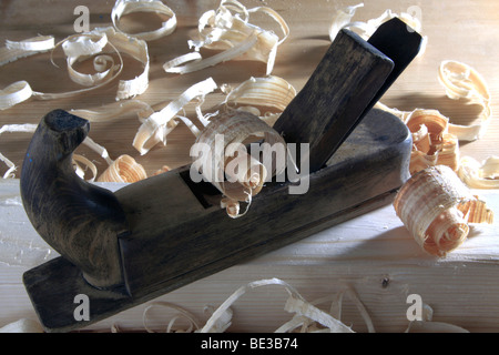 Antique plane with wood shavings Stock Photo