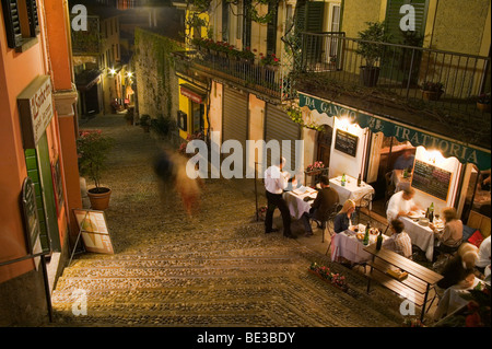 Customers enjoy dinner at an outdoor cafe in Bellagio, Italy. Stock Photo