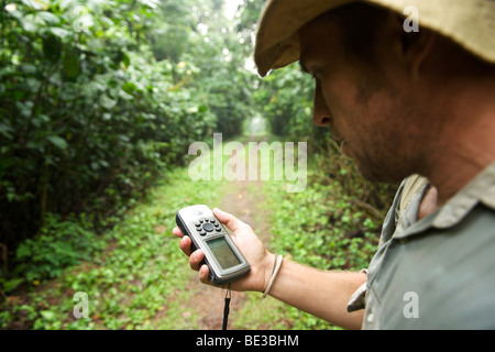 Man with a GPS in the rain forests of Bwindi Impenetrable National Park in southern Uganda. Stock Photo