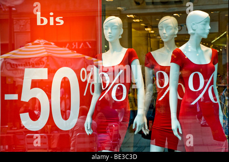 Summer sale, shop window with window dummies, price reduction - 50% discount Stock Photo