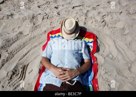 Man wearing a straw hat on the beach, Southhampton, New York Stock Photo