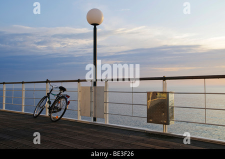 Bike leaning against railing of the pier, in the Heringsdorf seaside resort, Usedom Island, Mecklenburg-Western Pomerania, Germ