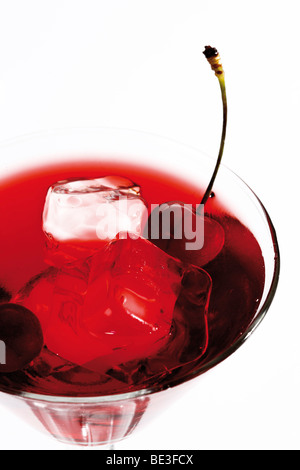 Red drink with ice cubes and cherry Stock Photo