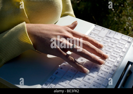 Woman's hand on laptop computer keyboard, close-up Stock Photo