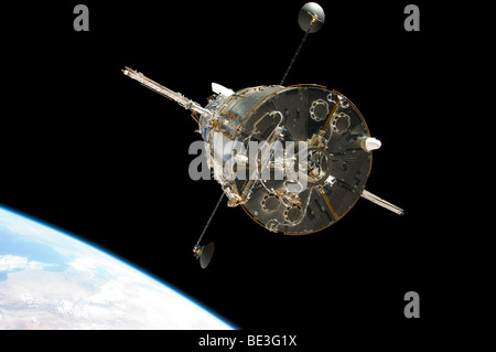 The Hubble Space Telescope in orbit above Earth. Stock Photo