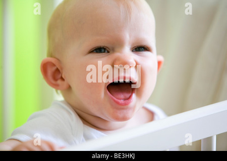 A one-year-old girl in her crib Stock Photo