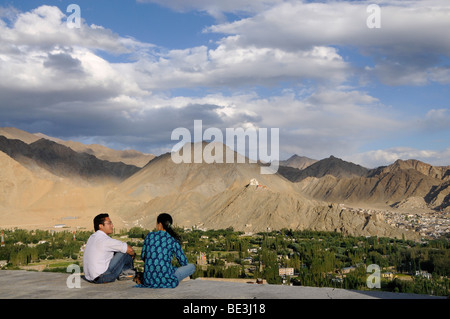 Ladakhi people looking on the Leh oasis with Gonkhang monastery and castle ruins on the mountain, Ladakh, India, Himalayas, Asia Stock Photo
