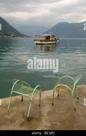 two chairs on the shores of the straight of kotor, montenegro Stock Photo