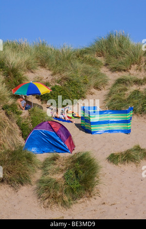 colourful beach tents on the sand dunes at Croyde Bay, North Devon, England, UK on a beautiful summer's day in August 2009 Stock Photo