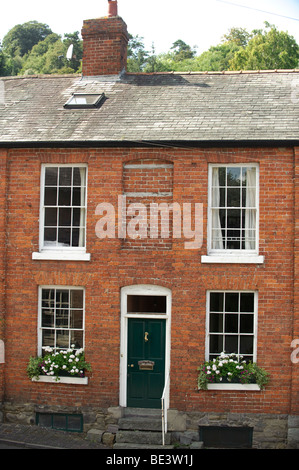 A small Georgian era house in Montgomery Powys wales with a bricked up window to avoid paying the window tax - daylight robbery Stock Photo