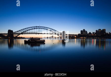 View across Lavendar Bay to the Sydney Opera House and Harbour Bridge at dawn. Blues Point, Sydney, New South Wales, AUSTRALIA Stock Photo