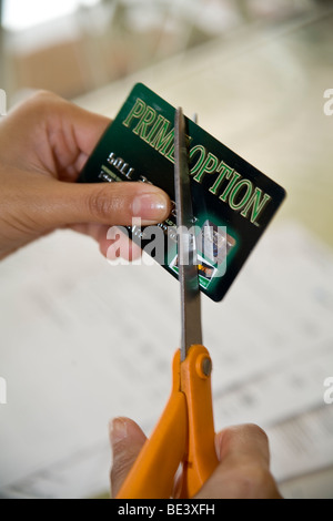 Canadian Ojibwa Indian woman distressed by credit card bill closes account and cuts up card.  MR  © Myrleen Pearson Stock Photo