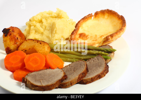 A meal of roast beef with carrots, mashed potatoes, asparagus and Yorkshire pudding. Stock Photo