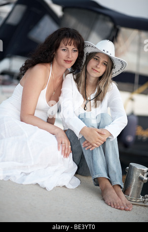 Two young women in front of a yacht Stock Photo