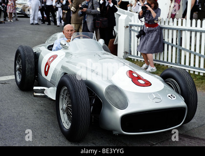 Sir Stirling Moss celebrates his 80th birthday driving a Mercedes Benz racing car on to the track at the Goodwood Revival Stock Photo