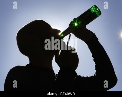 YOUNG MAN DRINKING BEER.