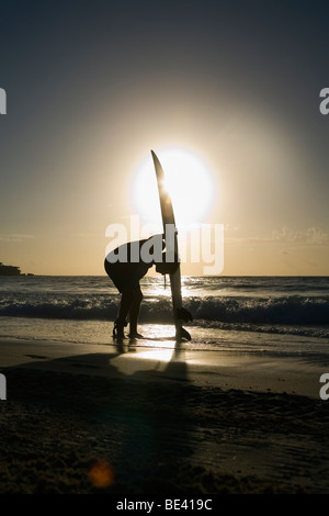 A surfer standing with surfboard at beach.  Bondi Beach. Sydney, New South Wales, AUSTRALIA Stock Photo