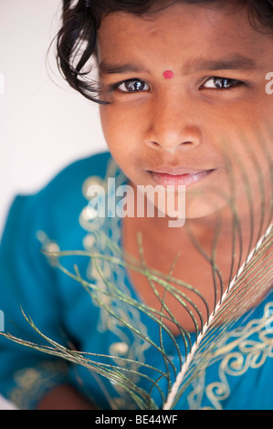 Indian girl holding a peacock feather. India Stock Photo