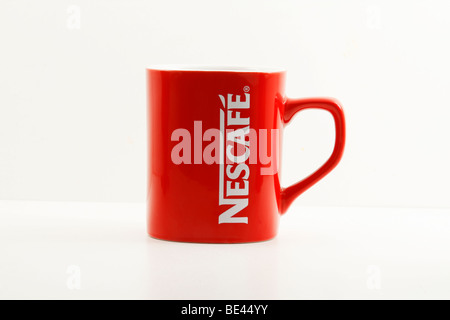 Red Nescafe coffee mug (brim - cup) isolated (cut-out) on white background. Stock Photo