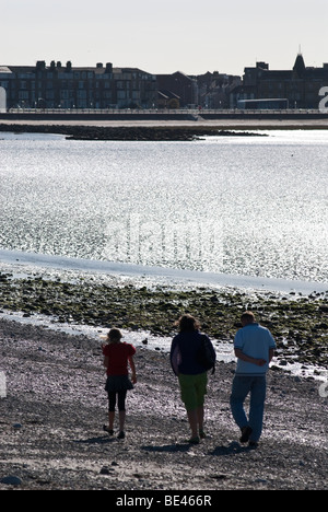 Walking along the sea front at Morecambe Stock Photo