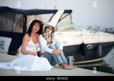 Two young women in front of a yacht Stock Photo