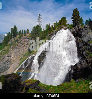 Rainbow near Waterfall Kokkol - the biggest waterfall of the Altai Mountains. East Kazakhstan Stock Photo