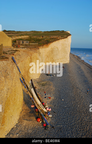 Birling Gap with cliffs and fishing boat at sunset Stock Photo