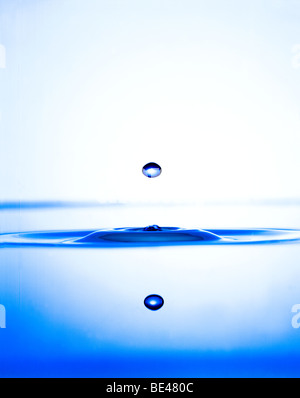 Water drop rising on the surface of water Stock Photo - Alamy