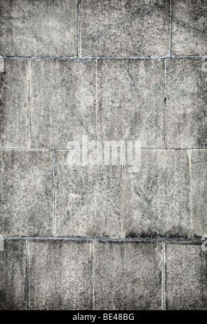 Grunge surface of old concrete wall covered with grey plates Stock Photo