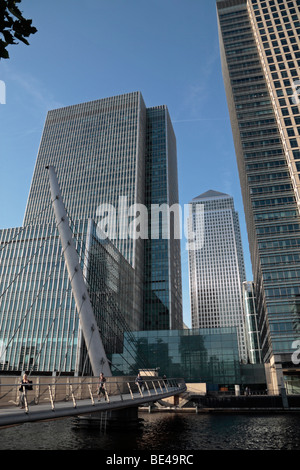 Canary Wharf towers amongst the towering skyscrappers of London Docklands, UK. Wilkinson Bridge in the foreground. Stock Photo