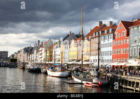 Dark and threatening clouds over Nyhavn, Copenhagen, the old harbour quarter famous for old painted houses and waterside cafes. Stock Photo