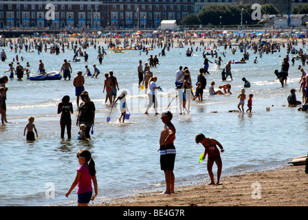 Holiday makers crowded onto the beach on a hot summer's day in Weymouth, Dorset, UK Stock Photo