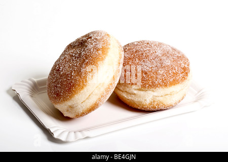 Two jam donuts on a paper plate Stock Photo