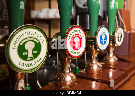 UK, England, Yorkshire, Haworth, Timothy Taylor’s Keighley Brewery beer hand pumps on bar Stock Photo