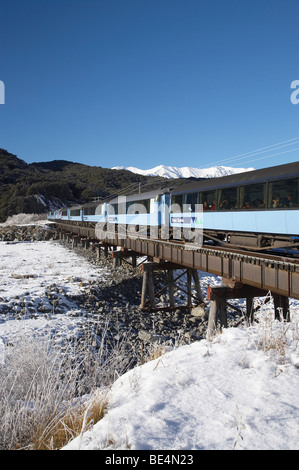 TransAlpine Train Crossing Bealey River, near Arthur's Pass, Canterbury, South Island, New Zealand Stock Photo