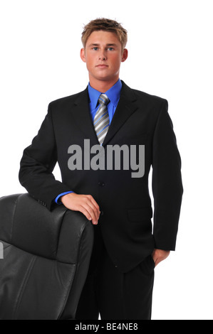 Young businessman standing with chair isolated on white Stock Photo